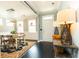 Hallway featuring black wood floors, a wooden table, and a view into the dining room at 2160 Pentland Dr, Charleston, SC 29412