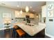 Well-lit kitchen features an island with granite countertops, updated appliances, and white cabinetry at 2160 Pentland Dr, Charleston, SC 29412