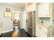 Kitchen with stainless steel refrigerator and a view into the adjacent dining area at 2160 Pentland Dr, Charleston, SC 29412