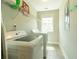 Bright laundry room with updated washer and dryer and storage shelves at 2160 Pentland Dr, Charleston, SC 29412