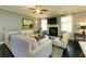 Open living area with fireplace, large sectional sofa and hardwood floors at 2160 Pentland Dr, Charleston, SC 29412