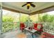 Relaxing screened porch with ceiling fan and cozy furniture overlooking a lush backyard at 2160 Pentland Dr, Charleston, SC 29412