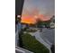 A colorful twilight sunset over a cozy neighborhood with well-manicured lawns and sidewalks at 2160 Pentland Dr, Charleston, SC 29412