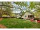 Spacious backyard featuring a fire pit area and screened in porch with mature trees at 225 Hanahan Plantation Cir, Hanahan, SC 29410