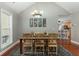 Dining room featuring modern chandelier, hardwood floors, and views into the living room at 225 Hanahan Plantation Cir, Hanahan, SC 29410