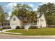 Charming yellow two-story home with front porch, palm trees, and well-manicured lawn at 225 Hanahan Plantation Cir, Hanahan, SC 29410