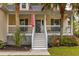 Close-up of the home's entry way with a charming front porch and manicured landscaping at 225 Hanahan Plantation Cir, Hanahan, SC 29410