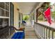 Cozy front porch with seating, overlooking the street and mature landscaping at 225 Hanahan Plantation Cir, Hanahan, SC 29410