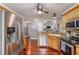 Well-lit eat-in kitchen featuring stainless steel appliances, granite counters, and hardwood floors at 225 Hanahan Plantation Cir, Hanahan, SC 29410