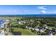 An aerial view of a coastal community that is nestled among lush green trees and a golf course at 229 Linkside Villas # 1/3 Share, Edisto Beach, SC 29438