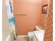 Bathroom features shower with beach themed curtain and orange floral wallpaper at 229 Linkside Villas # 1/3 Share, Edisto Beach, SC 29438