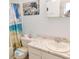 Bathroom features shower with ocean themed curtain, matching toilet seat, and dolphin art at 229 Linkside Villas # 1/3 Share, Edisto Beach, SC 29438