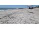 A sunny beach with people fishing by the shoreline at 229 Linkside Villas # 1/3 Share, Edisto Beach, SC 29438