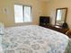 Bedroom featuring queen bed with ocean themed bedding, a dresser, and a mirror at 229 Linkside Villas # 1/3 Share, Edisto Beach, SC 29438
