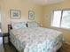 Bedroom features a queen bed with beach themed decor and a large window at 229 Linkside Villas # 1/3 Share, Edisto Beach, SC 29438