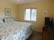 Bedroom features a queen bed with beach themed bedding and a large window at 229 Linkside Villas # 1/3 Share, Edisto Beach, SC 29438