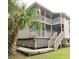 Exterior view of a two-story home featuring a deck and staircase at 229 Linkside Villas # 1/3 Share, Edisto Beach, SC 29438