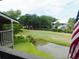 Scenic view from a balcony overlooking a lush green golf course and serene pond at 229 Linkside Villas # 1/3 Share, Edisto Beach, SC 29438