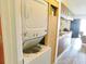 Efficient laundry area with stacked washer and dryer units and built-in storage at 229 Linkside Villas # 1/3 Share, Edisto Beach, SC 29438