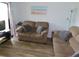 Living room showcases plush couches, beach themed decor, and bright natural light at 229 Linkside Villas # 1/3 Share, Edisto Beach, SC 29438