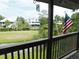 Balcony view showing American flag, pond, golf course, and backyard of other homes at 229 Linkside Villas # 1/3 Share, Edisto Beach, SC 29438