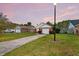 Exterior view of a brick home with an attached garage and a mature lawn at 234 Two Hitch Rd, Goose Creek, SC 29445