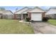 Quaint brick home with attached garage, showcasing neat landscaping and inviting curb appeal at 234 Two Hitch Rd, Goose Creek, SC 29445