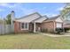 Charming single-story brick home featuring a well-manicured lawn and cozy front porch at 234 Two Hitch Rd, Goose Creek, SC 29445