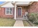 Inviting front porch features brick accents, a rocking chair, and manicured landscaping at 234 Two Hitch Rd, Goose Creek, SC 29445