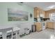 Cozy kitchen featuring wooden cabinets, white appliances, and white tile flooring at 234 Two Hitch Rd, Goose Creek, SC 29445