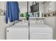 Well organized laundry room with modern washer and dryer and ample shelving for storage at 234 Two Hitch Rd, Goose Creek, SC 29445