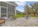 Well-maintained backyard featuring a patio, screened porch, and lush greenery at 2383 Lenwick Hall Ln, Johns Island, SC 29455