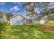 Lush backyard view with a large tree, screened-in porch, and patio area, ideal for outdoor enjoyment at 2383 Lenwick Hall Ln, Johns Island, SC 29455