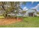 Expansive backyard with a large tree, screened porch, and a patio, offering a serene outdoor space at 2383 Lenwick Hall Ln, Johns Island, SC 29455