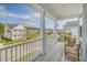 Inviting covered balcony boasts comfortable wicker seating and serene neighborhood views at 2383 Lenwick Hall Ln, Johns Island, SC 29455