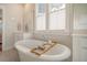 Bright bathroom featuring a soaking tub and double windows with privacy shades at 2383 Lenwick Hall Ln, Johns Island, SC 29455