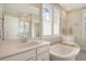 Light-filled bathroom showcasing dual sinks, soaking tub, and glass-enclosed shower with subway tile at 2383 Lenwick Hall Ln, Johns Island, SC 29455