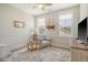 Comfortable bedroom provides neutral colors, natural lighting, and a cozy chair at 2383 Lenwick Hall Ln, Johns Island, SC 29455
