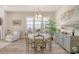 Bright dining area with seating for six, light fixture, and art on the wall at 2383 Lenwick Hall Ln, Johns Island, SC 29455