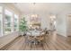 Dining room has wood floors, windows, and a hanging light fixture at 2383 Lenwick Hall Ln, Johns Island, SC 29455