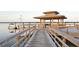 A wooden dock featuring a covered gazebo at the end over looking the water, ideal for relaxation at 2383 Lenwick Hall Ln, Johns Island, SC 29455