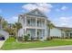 Beautiful two-story home with double porches, manicured lawn, and palm trees at 2383 Lenwick Hall Ln, Johns Island, SC 29455