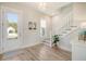 Bright entryway with wood-look floors, staircase, and natural light at 2383 Lenwick Hall Ln, Johns Island, SC 29455