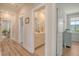Hallway leading to a bathroom with a vanity and a framed mirror at 2383 Lenwick Hall Ln, Johns Island, SC 29455