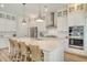 Spacious kitchen with white cabinets, stainless steel appliances, and island with a sink and bar stool seating at 2383 Lenwick Hall Ln, Johns Island, SC 29455