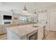 Open concept kitchen features stainless steel appliances, large island with bar stool seating that opens to living room at 2383 Lenwick Hall Ln, Johns Island, SC 29455