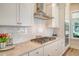 Beautiful kitchen features gas cooktop and stainless steel appliances against white cabinetry and quartz countertops at 2383 Lenwick Hall Ln, Johns Island, SC 29455