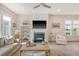 Cozy living room with fireplace, ceiling fan, and comfortable seating and built-in shelves at 2383 Lenwick Hall Ln, Johns Island, SC 29455
