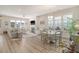 Bright living room features fireplace, wood floors, neutral colors, and dining area at 2383 Lenwick Hall Ln, Johns Island, SC 29455