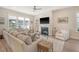 Open living room features fireplace, TV, and lots of natural light at 2383 Lenwick Hall Ln, Johns Island, SC 29455